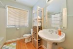 Bathroom is adjacent to the two bedrooms and has a shower/tub combo.